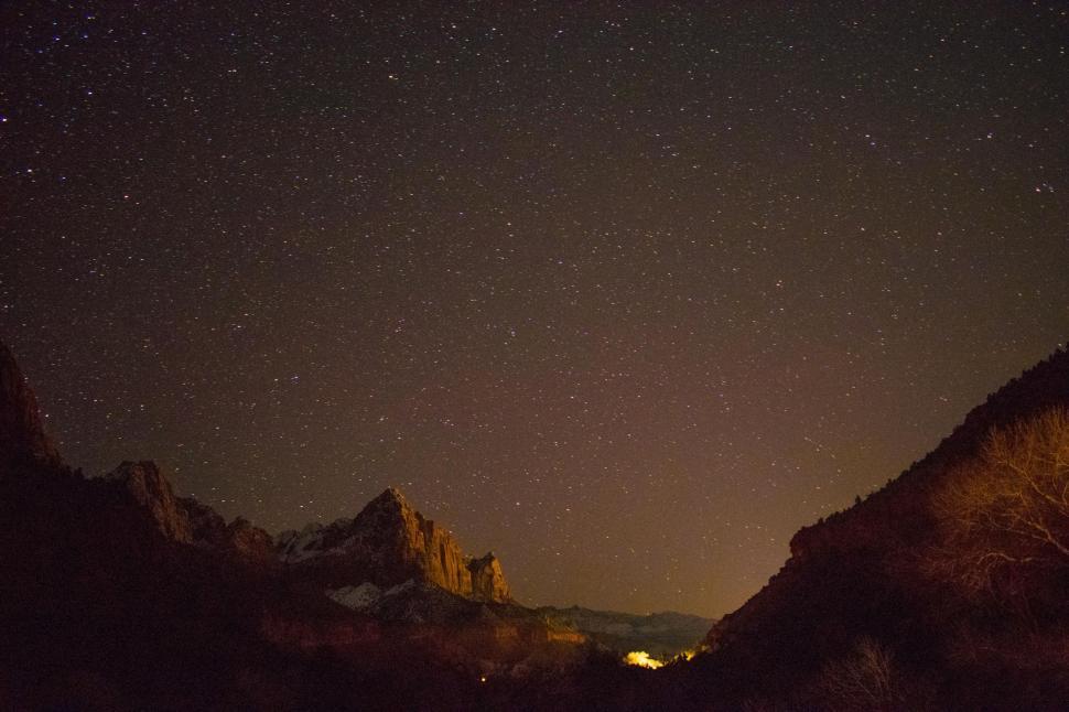 Free Image of Star-Filled Night Sky Above Mountain Range 