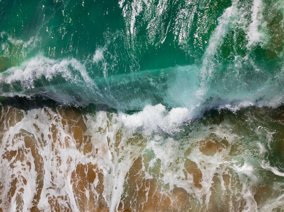 Free Image of Aerial View of Wave Breaking on Beach 