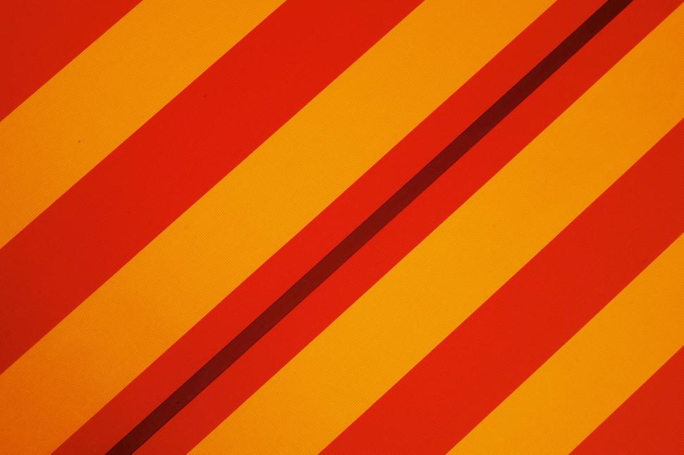 Free Image of Close Up of a Red and Yellow Striped Wall 