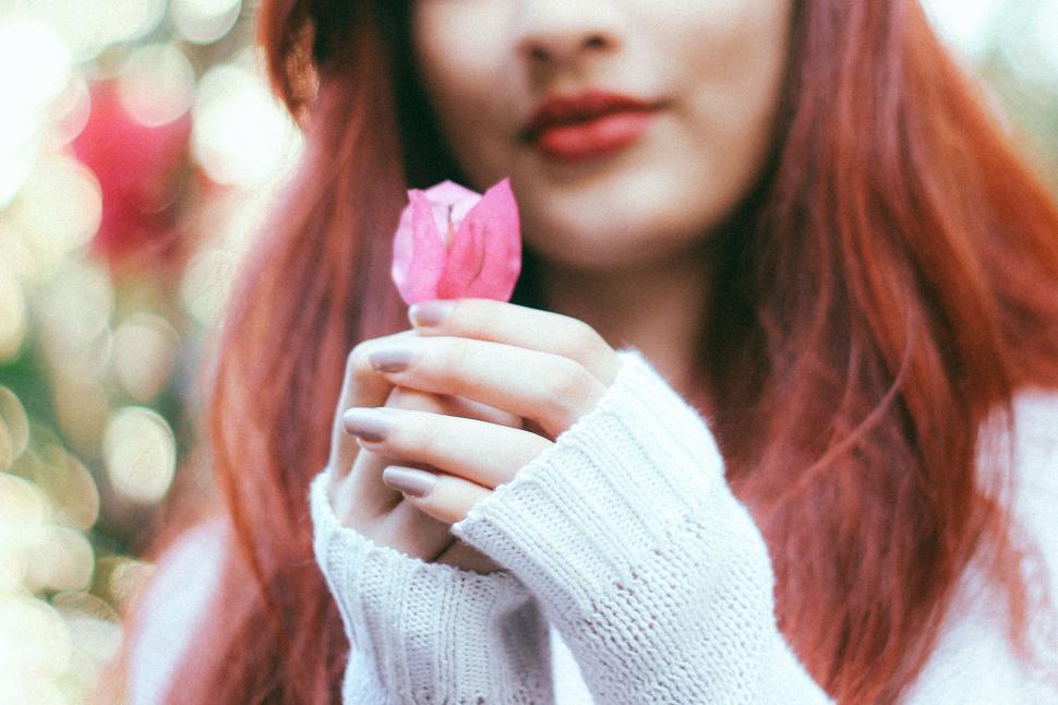 Free Image of Woman Holding Pink Flower 
