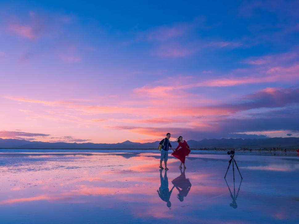 Free Image of Couple Standing on Top of Beach 