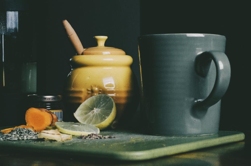 Free Image of A Table With Coffee Cup and Cutting Board 