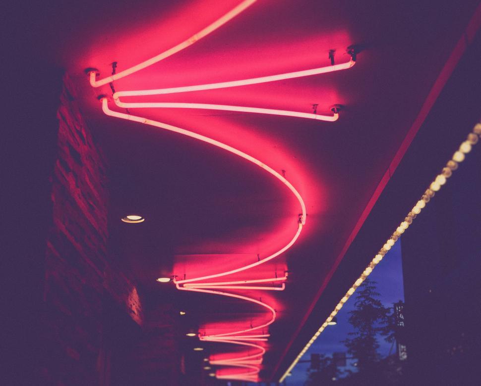 Free Image of Red Neon Sign Hanging From Building 