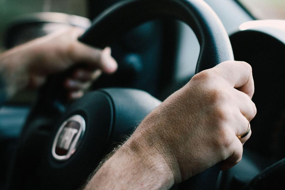 Free Image of Man Driving Car With Hands on Steering Wheel 