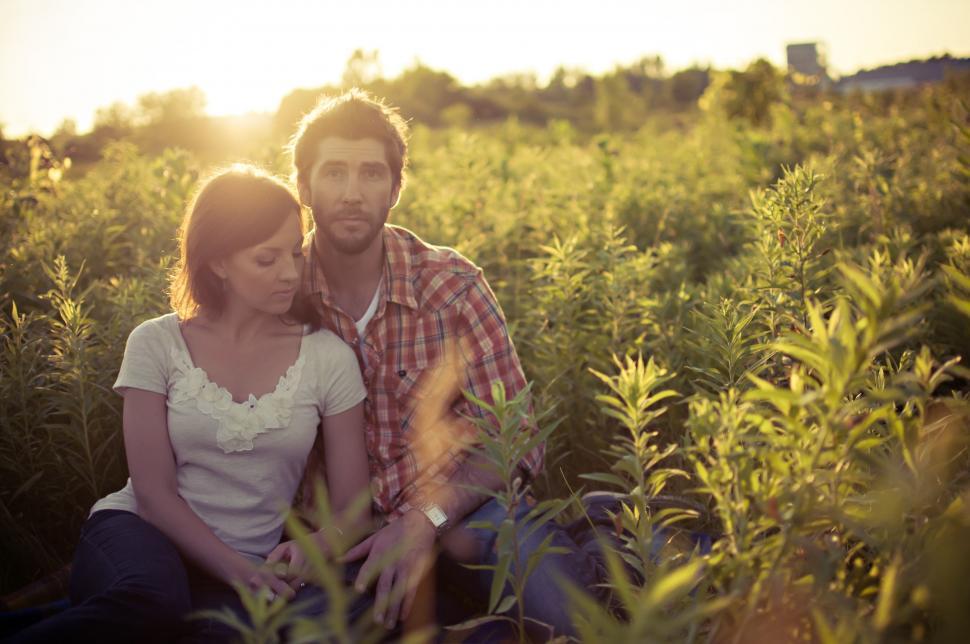 Free Image of A Man and a Woman Sitting in a Field 