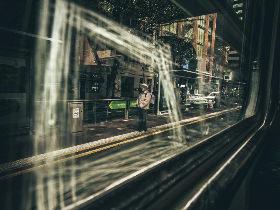Free Image of Man Standing on Train Platform Next to Window 