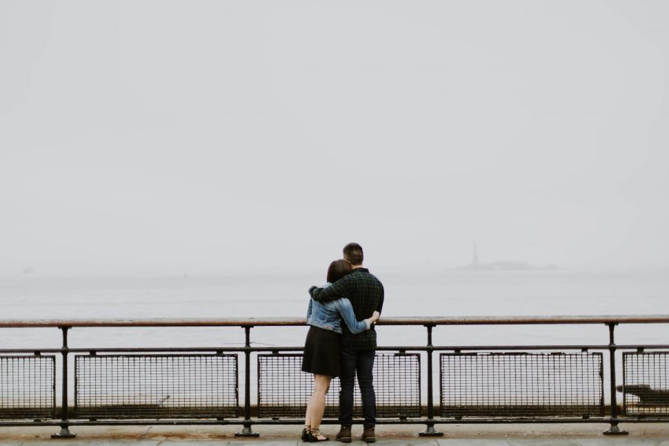 Free Image of Man and Woman Embracing on Pier 