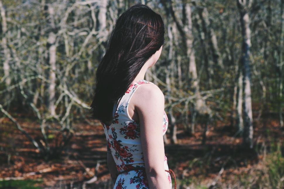 Free Image of Woman in Dress Standing in Woods 