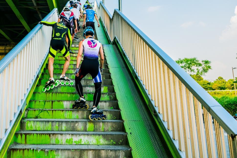 Free Image of Group of People Riding Skateboards Down Stairs 