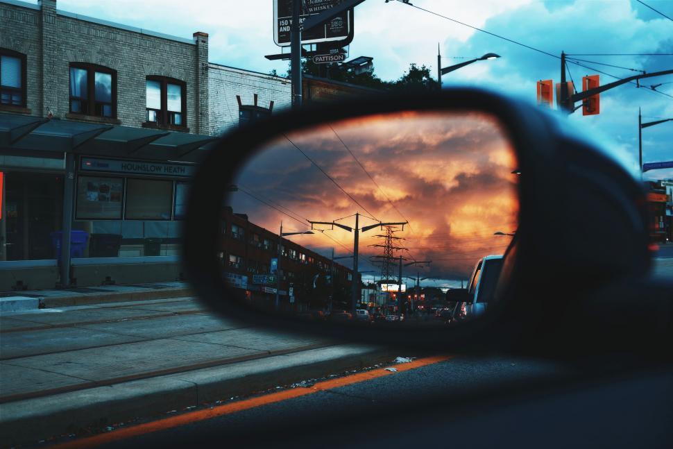 Free Image of Rear View Mirror on a Car in a City Street 