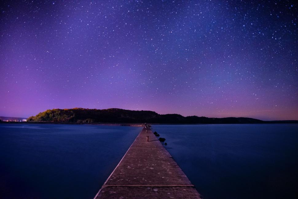 Free Image of Long Pier Under Star-Filled Night Sky 