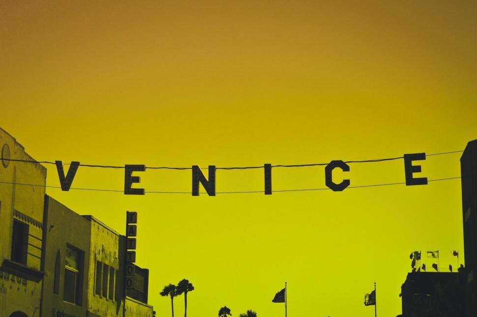 Free Image of Venice Sign Hanging From Wire 