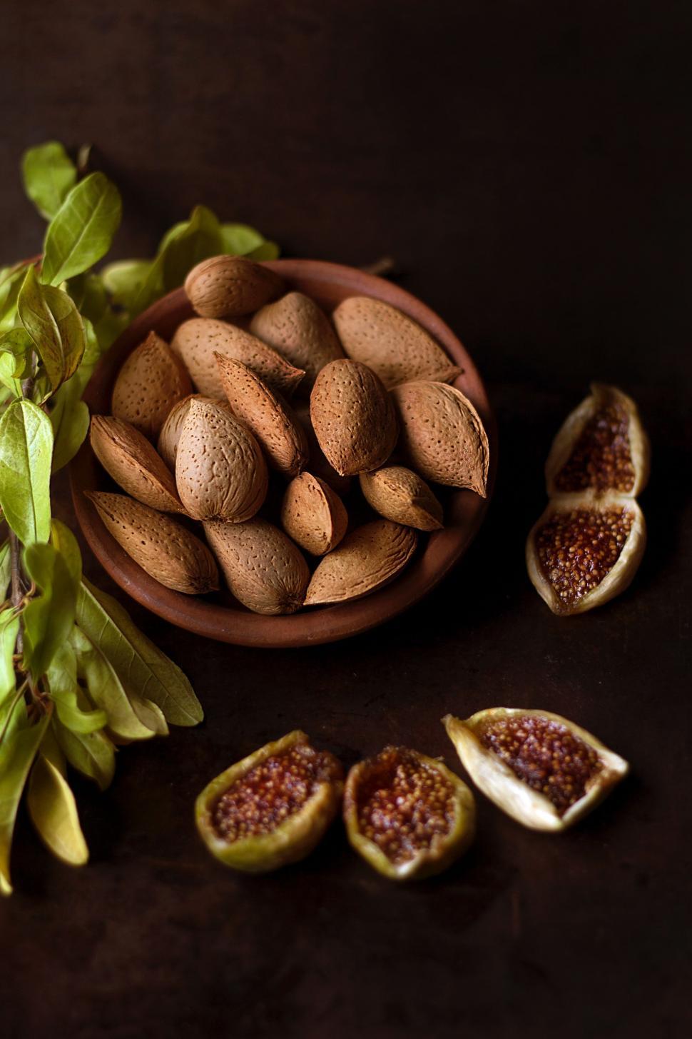 Free Image of Bowl of Nuts Next to Leaves 