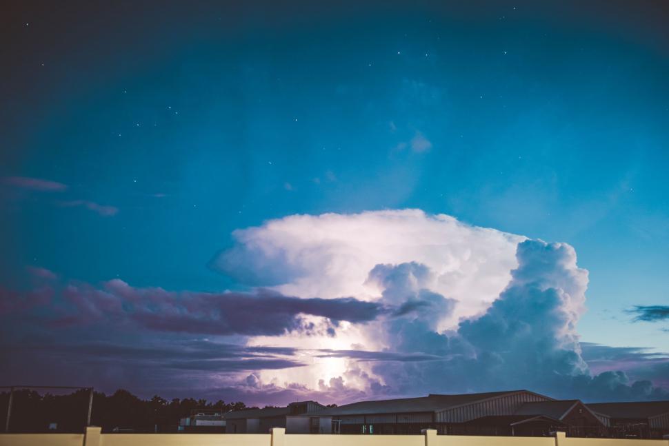 Free Image of Large Cloud Hanging Above a Fence 
