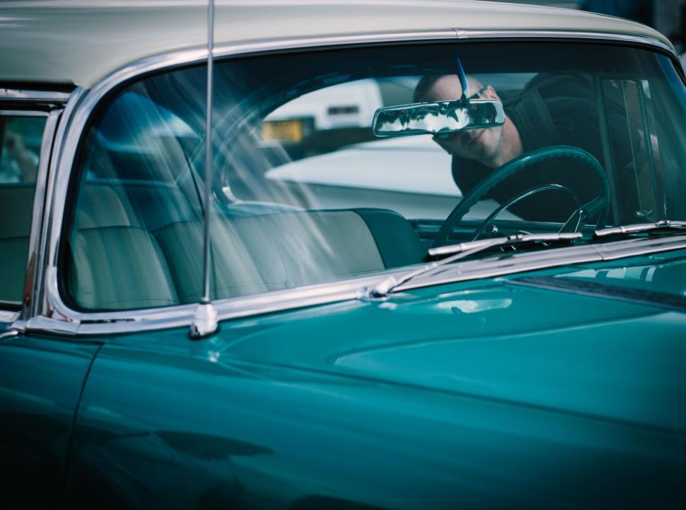 Free Image of Man Driving a Car While Holding a Cell Phone 