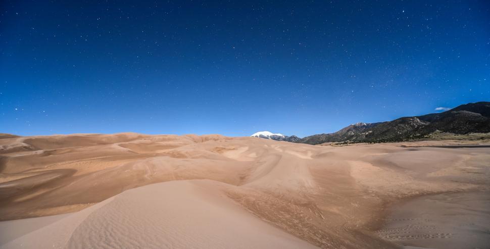 Free Image of Majestic Sand Dunes and Mountains in Desert Landscape 