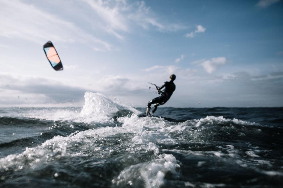 Free Image of Man Kite Surfing in Ocean on Sunny Day 