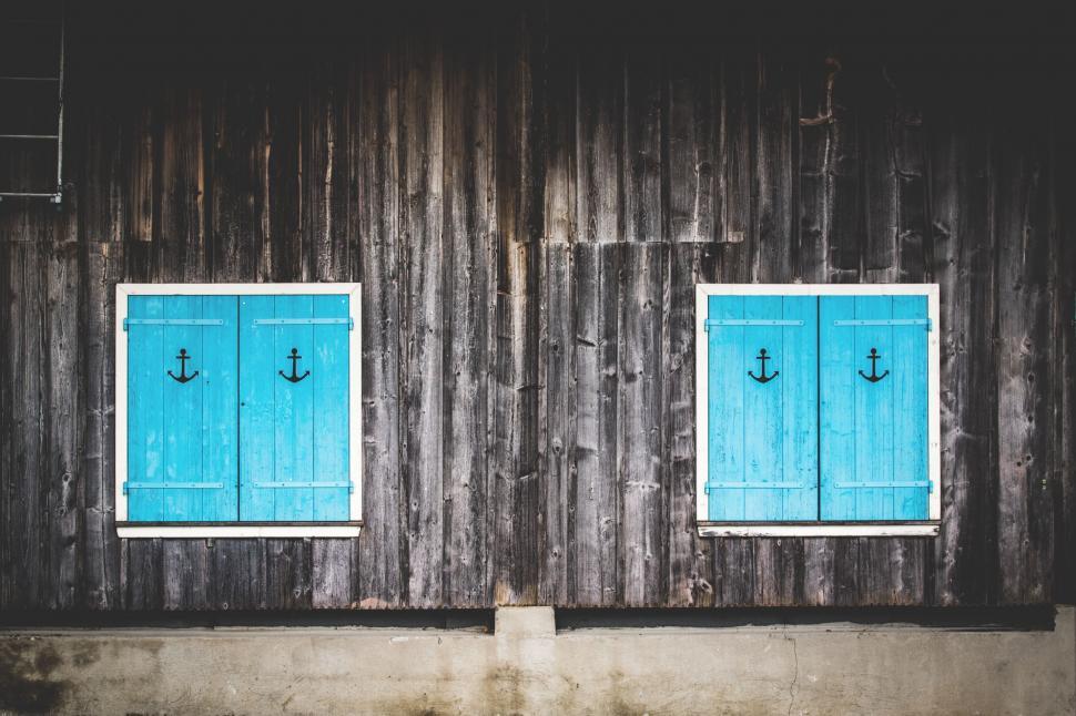 Free Image of Two Blue Windows With an Anchor Design 