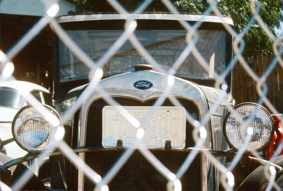 Free Image of Old Ford behind fence 