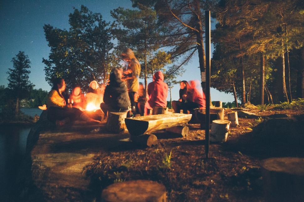 Free Image of Group of People Sitting Around a Campfire 