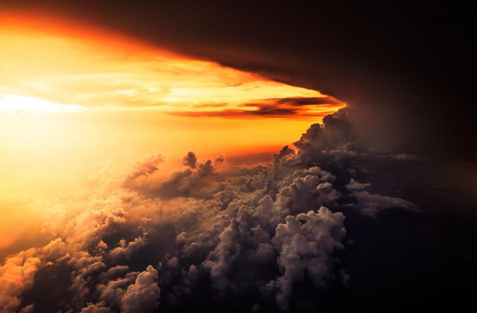 Free Image of Sun Shining Through Clouds Above Clouds 