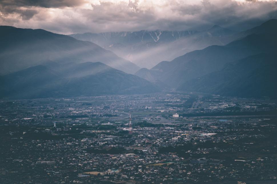 Free Image of Aerial View of City With Mountains in Background 