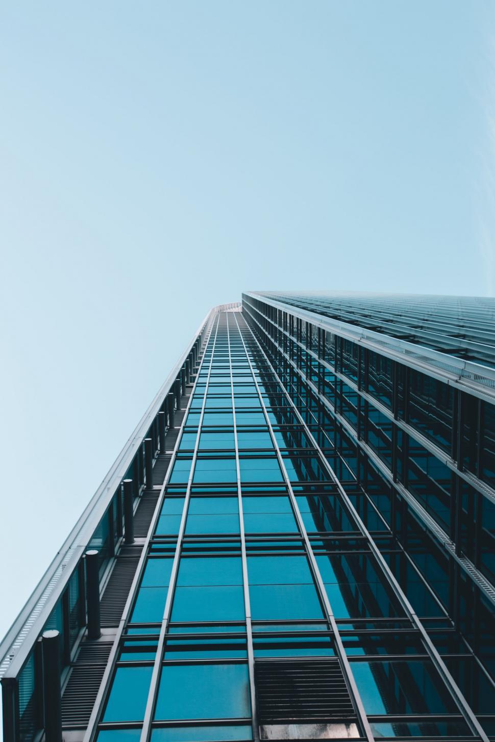 Free Image of Tall Building With Lots of Windows Against Blue Sky 