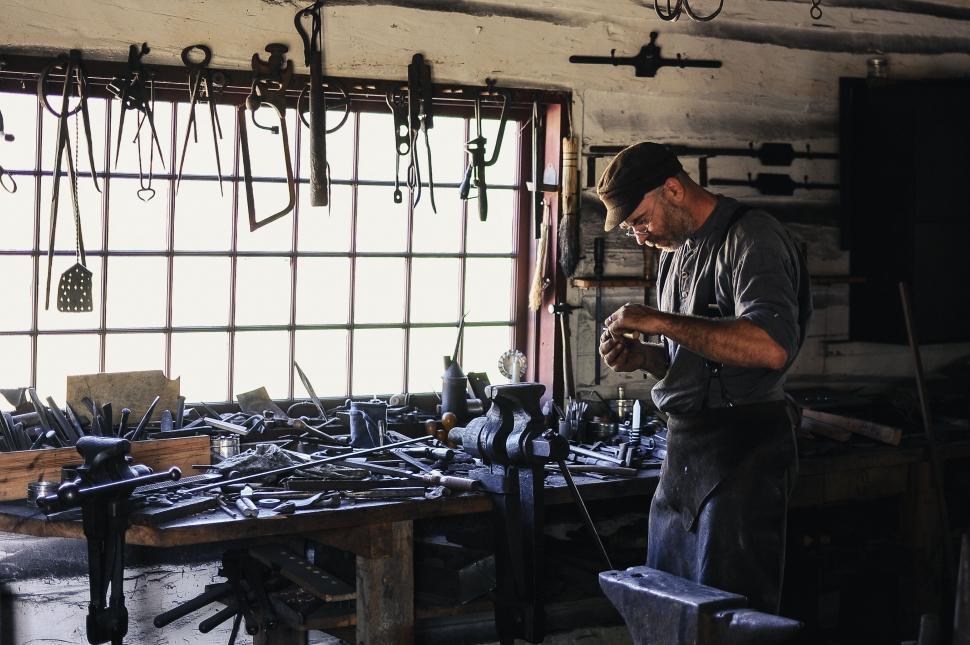 Free Image of Man Working in a Workshop With Various Tools 