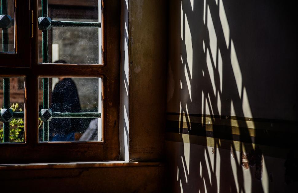 Free Image of Persons Shadow Standing Before Window 