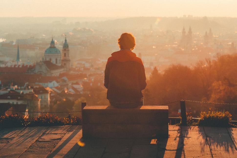 Free Image of Person Sitting on Bench Overlooking City 