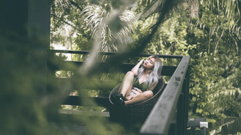 Free Image of Woman Sitting on Bench in Forest 