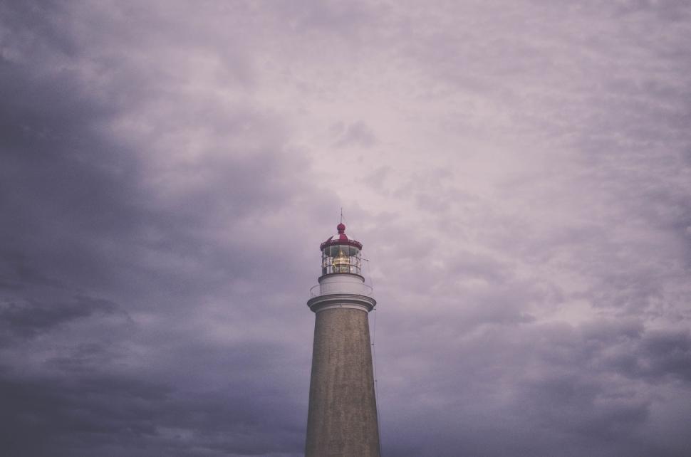 Free Image of Tall Lighthouse Beneath Cloudy Sky 