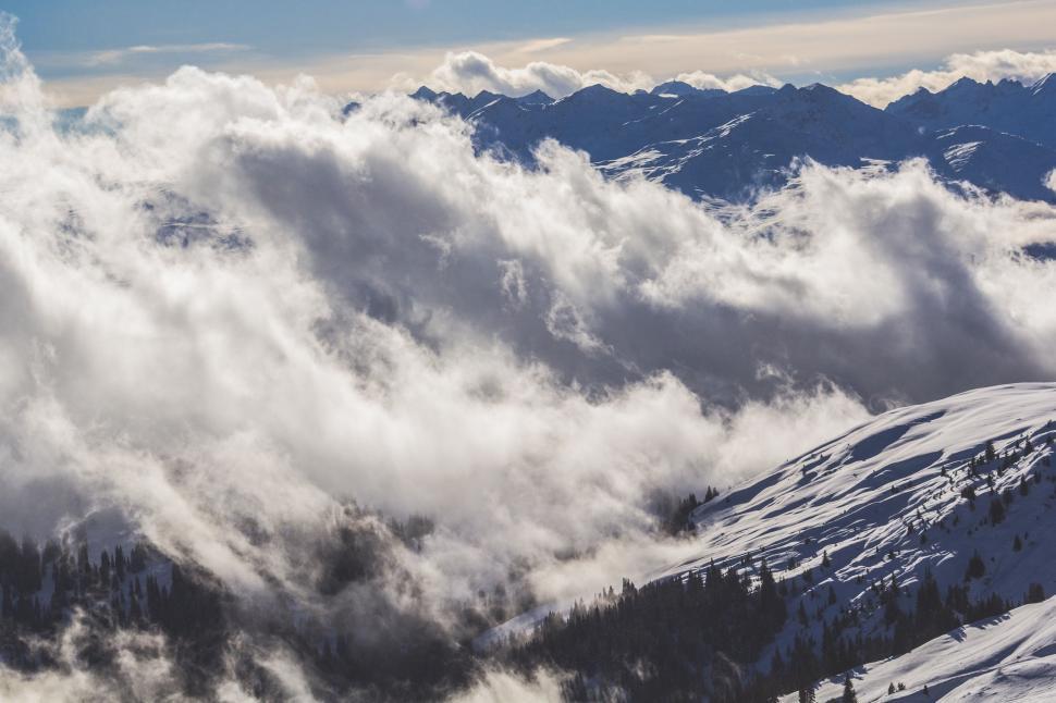 Free Image of Clouds Blanket Mountain Peak in a Mystical Scene 