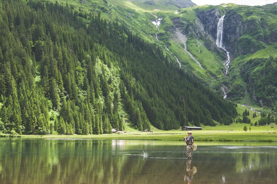 Free Image of Man Fishing on a Mountain Lake 