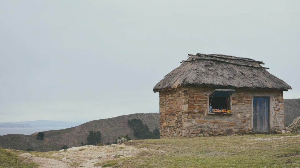 Free Image of Small Thatched Roof Building on Hill 