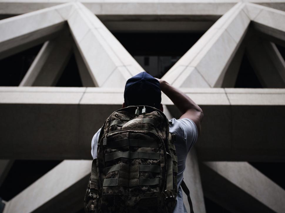 Free Image of Person With Backpack Standing in Front of Building 