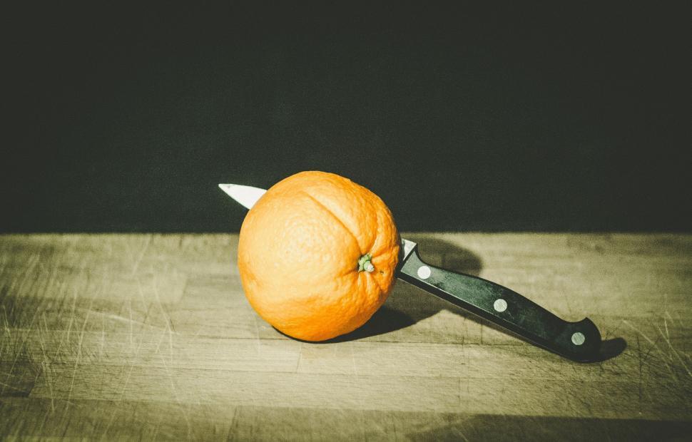 Free Image of Orange on Cutting Board With Knife 