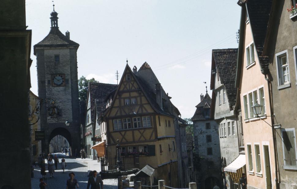 Free Image of Narrow Street With Clock Tower in Background 