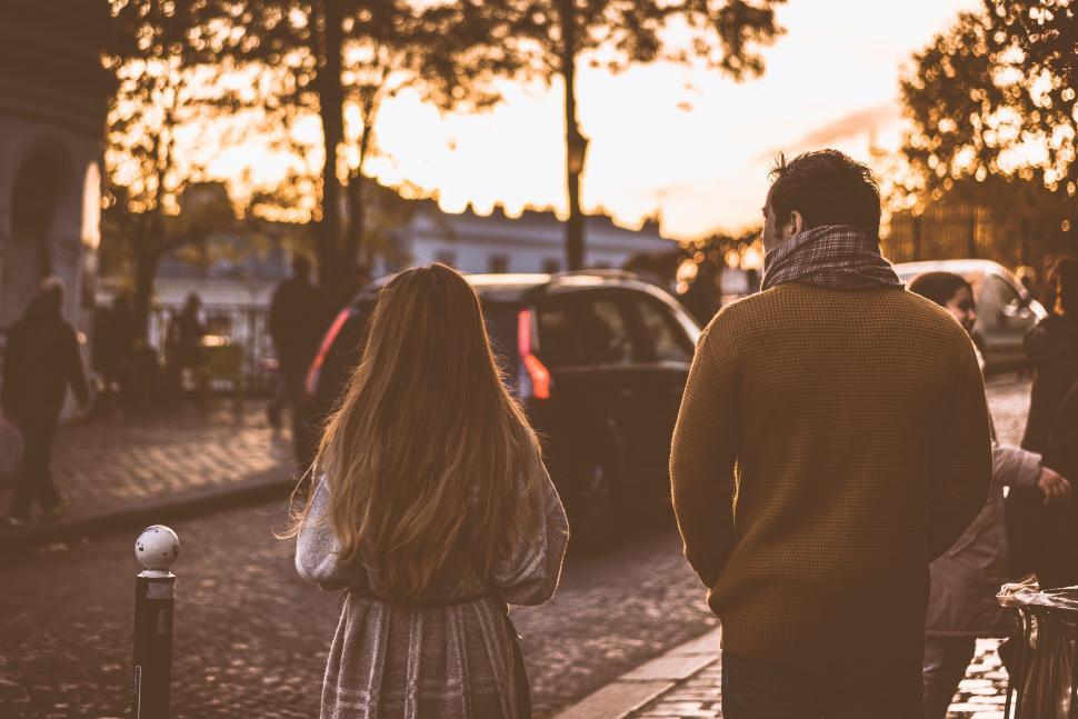 Free Image of A Man and a Woman Walking Down a Street 