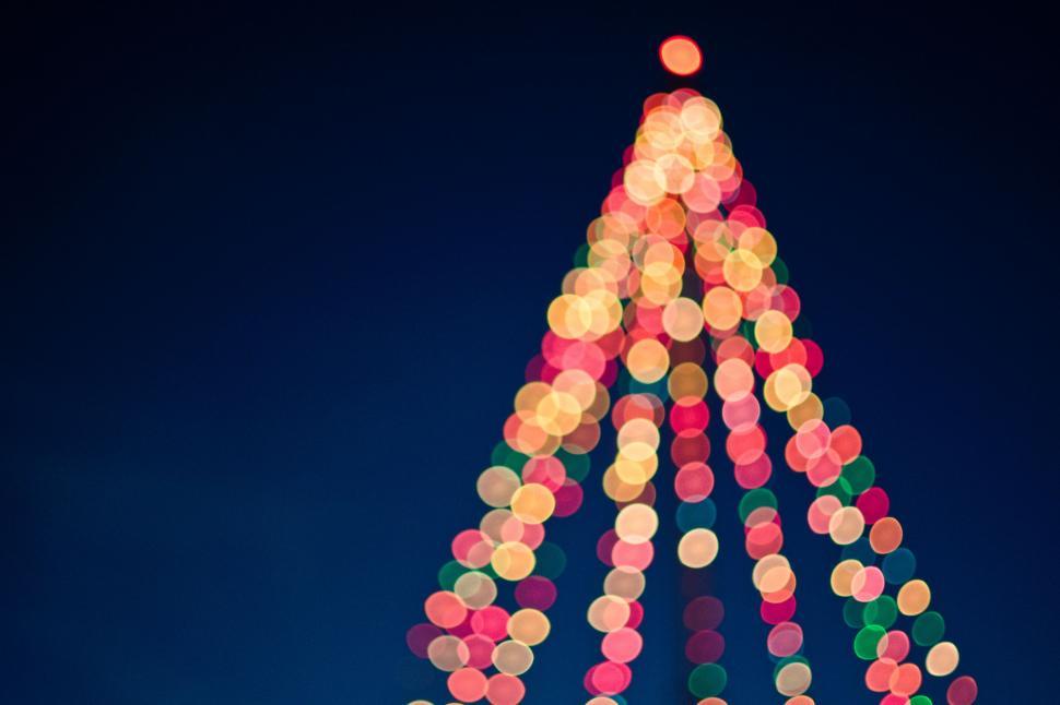 Free Image of Festive Christmas Tree Made of Lights Atop Building 