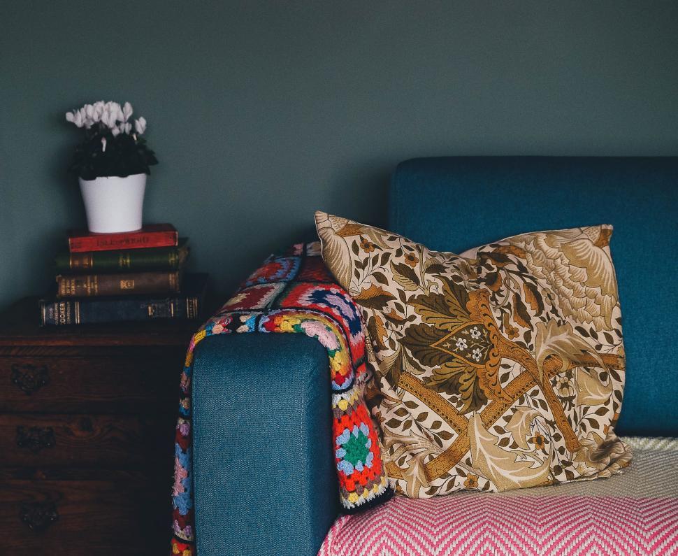 Free Image of Blue Couch With Colorful Throw Pillow 