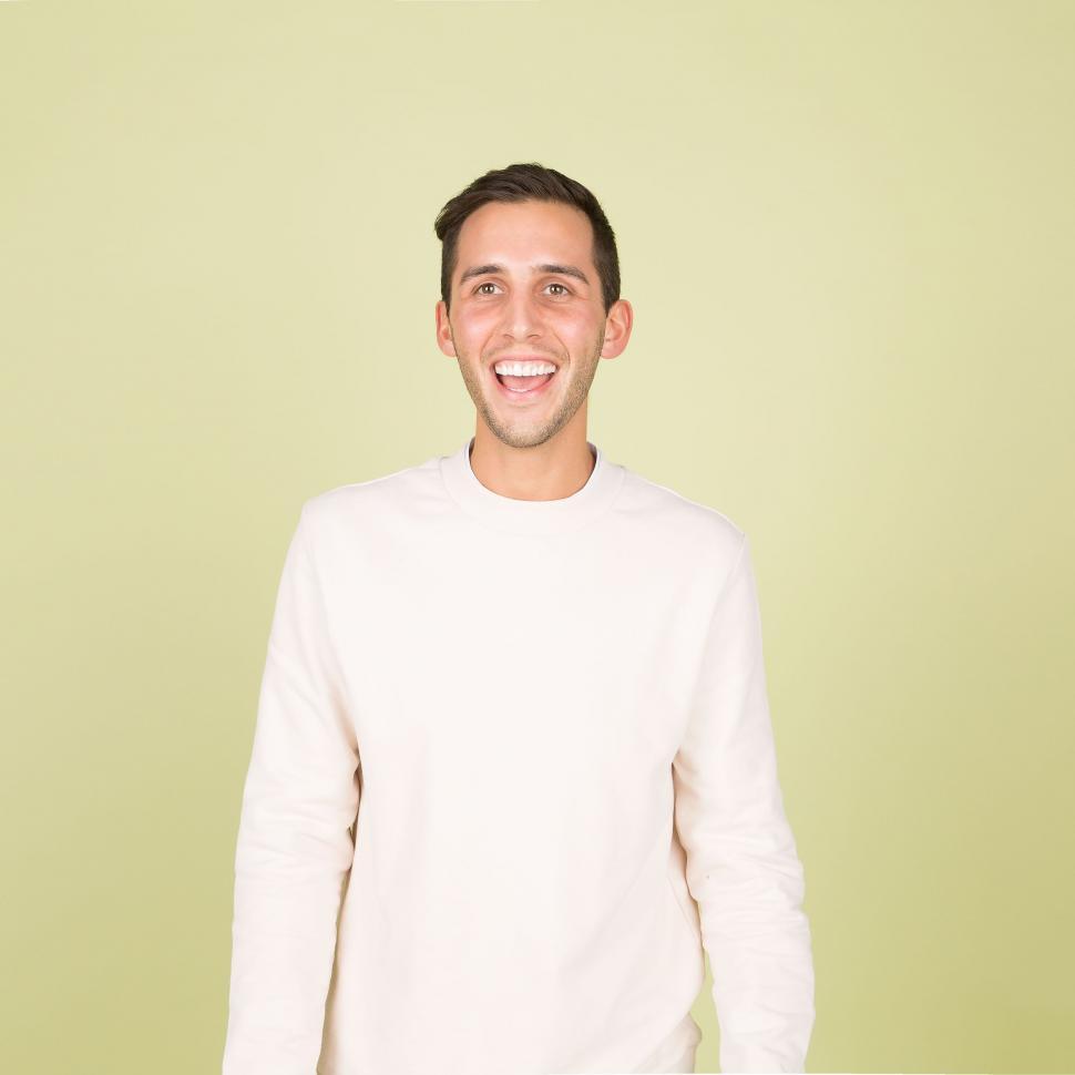 Free Image of Smiling Man in White Sweater 