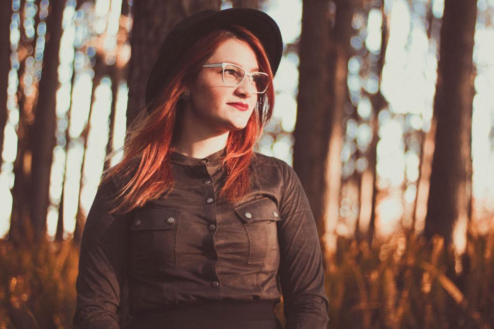 Free Image of Woman With Red Hair Wearing Hat and Glasses 