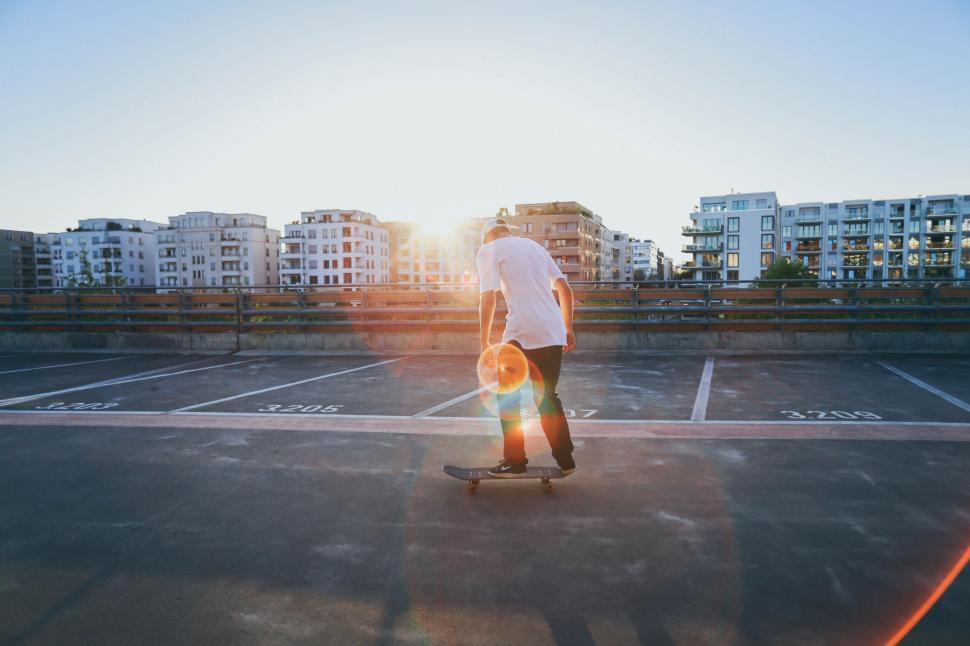 Free Image of Man Riding Skateboard on Top of Parking Lot 