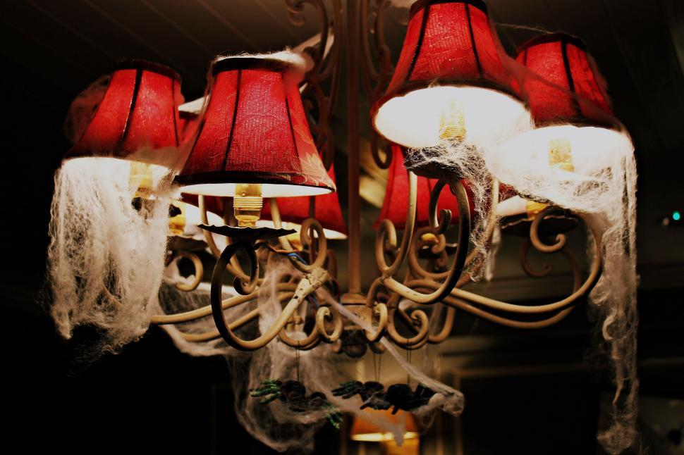 Free Image of Chandelier With Red Lamps Hanging 