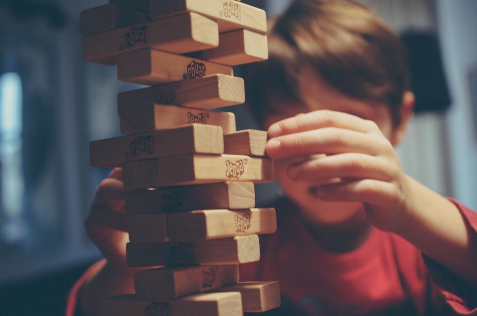 Free Image of Child Playing With Tower of Wooden Blocks 