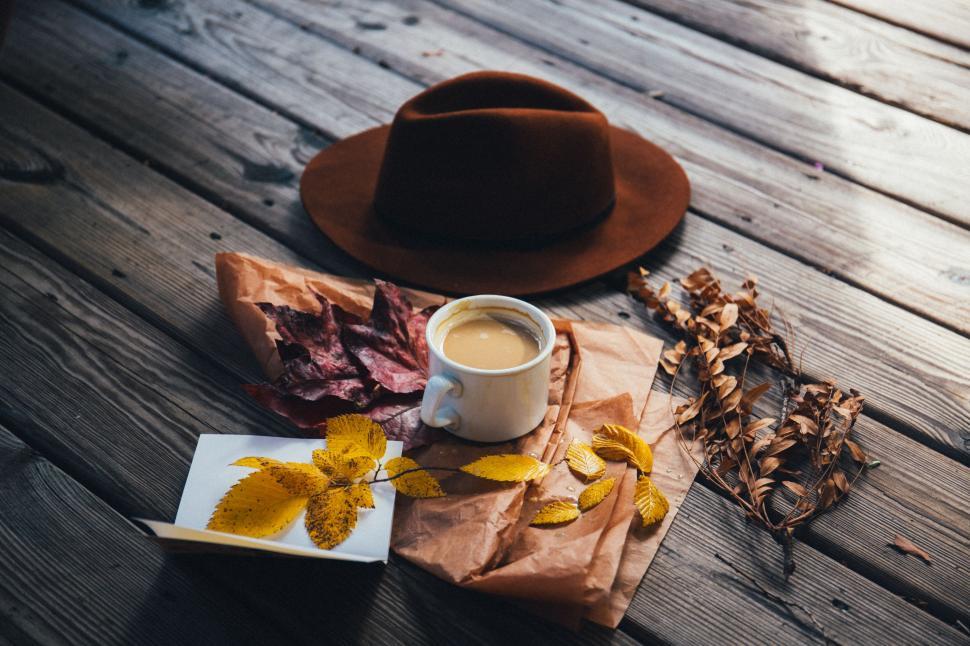 Free Image of Hat, Book, and Coffee Mug on Wooden Table 