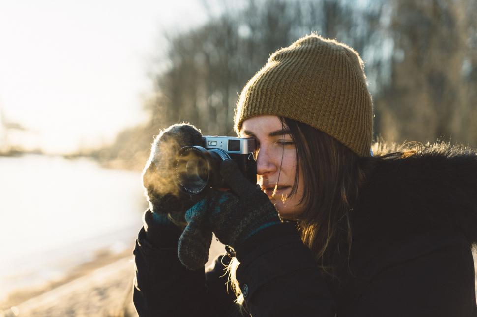 Free Image of Woman Capturing Dog With Camera 
