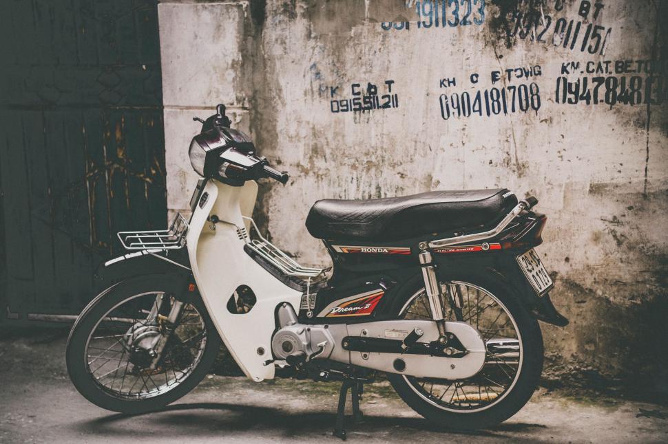 Free Image of Motor Scooter Parked in Front of Building 