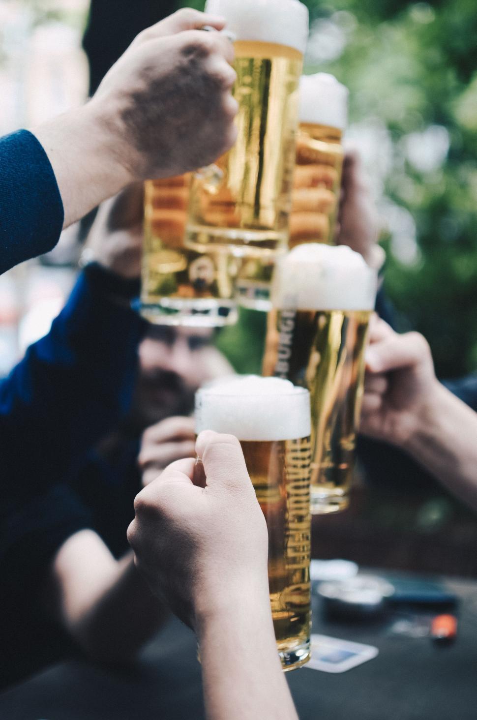 Free Image of Group of People Toasting With Glasses of Beer 